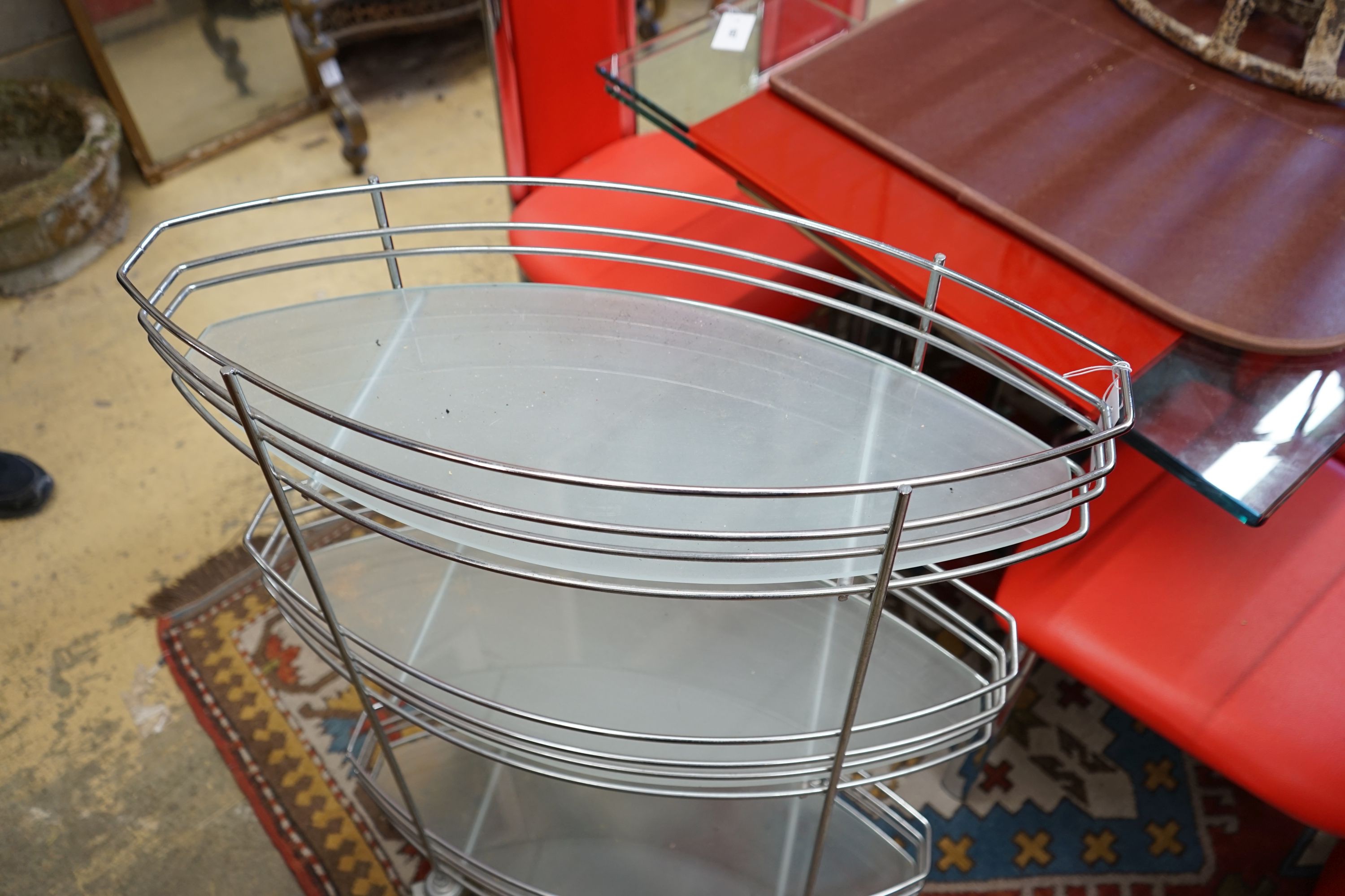 A three tier chrome and glass service trolley, width 65cm depth 27cm height 93cm